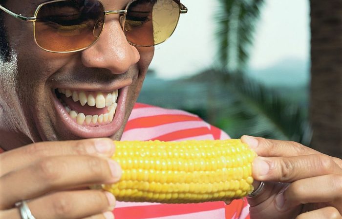 African American man eating corn